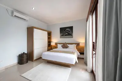 a bedroom with a white bed and a window at 5 Reviews, Huge Savings Best Locale In Seminyak in Badung