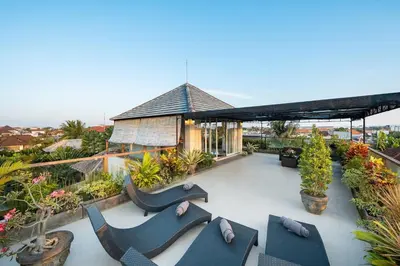 an outdoor patio with chairs and plants on a building at 5 Reviews, Huge Savings Best Locale In Seminyak in Badung