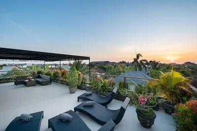 a patio with chairs and plants and a sunset at 5 Reviews, Huge Savings Best Locale In Seminyak in Badung