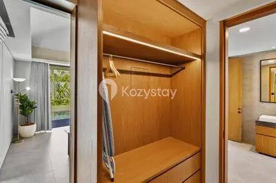 a pivot door in a bathroom with a dressing room at Andra Villa by Kozystay - Natadesa Resort Jimbaran in Jimbaran