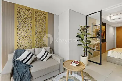 a living room with a couch and a table at Caraya by Kozystay - Nusa Dua in Nusa Dua