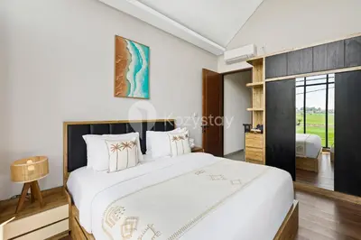 a bedroom with a large bed in a room at Manisha Villa by Kozystay - Seminyak in Seminyak