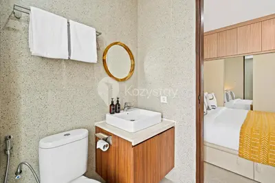 a bathroom with a sink and a toilet and a bed at Manisha Villa by Kozystay - Seminyak in Seminyak