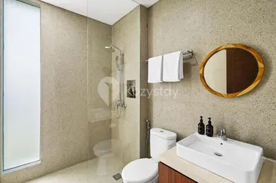 a bathroom with a toilet and a sink and a mirror at Manisha Villa by Kozystay - Seminyak in Seminyak