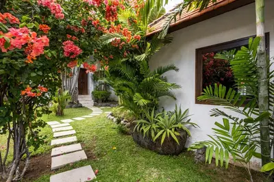 a garden with pink flowers on a house at Seminyak Most Wanted Villa for family vacation in Seminyak