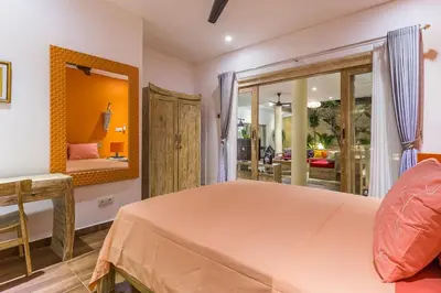 a bedroom with a bed and a mirror at Villa Josefine, 5 Bedroom pool, rooftop, pool table in Seminyak