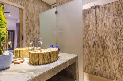 a bathroom with a wooden sink and a shower at Villa Josefine, 5 Bedroom pool, rooftop, pool table in Seminyak