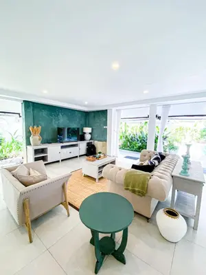 a living room with a couch and a table at Villa Drupadi 16 in Seminyak