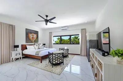a bedroom with a bed and a flat screen tv at Villa Drupadi 16 in Seminyak