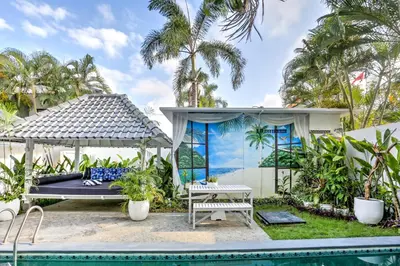a villa with a pool and a gazebo at Villa Drupadi 16 in Seminyak