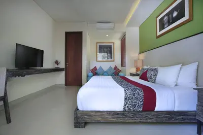 a bedroom with a large bed and a television at Royal Samaja Villas in Seminyak