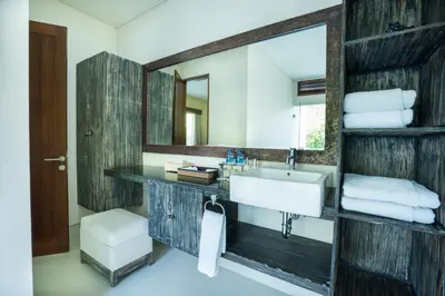 a bathroom with a sink and a mirror at Royal Samaja Villas in Seminyak