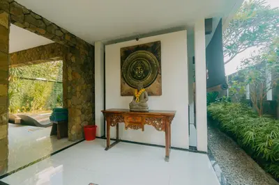 a room with a table and a picture on the wall at Villa C31 Seminyak in Seminyak