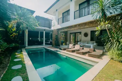 a swimming pool in front of a house at Villa C31 Seminyak in Seminyak