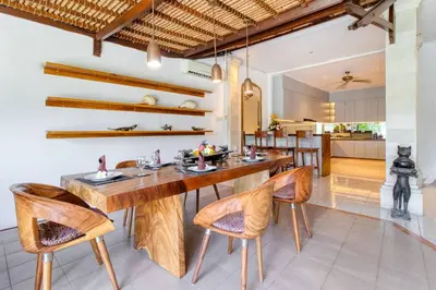 a dining room with a wooden table and chairs at 3BR Seminyak Oasis, Sleeps 6, Walk to RestBars in Seminyak