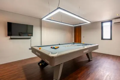 a room with a pool table in a room with a tv at Villa Narda Seminyak by Nagisa Bali in Legian