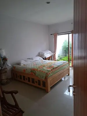 a bedroom with a bed and a sliding glass door at Karmani Villa Managed by Alyssa Villa Management in Ujung