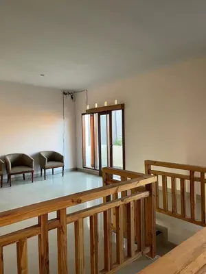 a room with two chairs and a table in it at Karmani Villa Managed by Alyssa Villa Management in Ujung