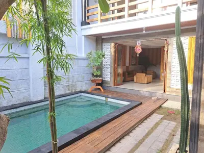 a swimming pool in the backyard of a house at Karmani Villa Managed by Alyssa Villa Management in Ujung