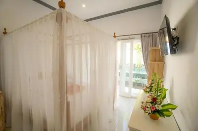 a white shower curtain in a room with a window at Deluxe room near seminyak beach in Seminyak