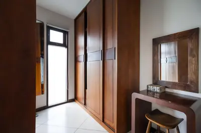 a room with a desk and a wooden cabinet at Villa K Seminyak by Premier Hospitality Asia in Seminyak