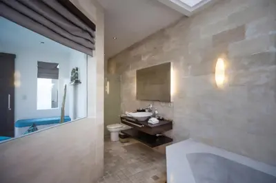 a bathroom with a sink and a toilet at Villa K Seminyak by Premier Hospitality Asia in Seminyak