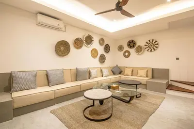 a living room with a couch and a table at Stunning 5BR Canggu Villa 400m from the Beach in Canggu
