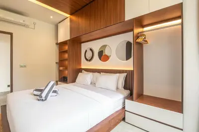 a bedroom with a bed with a phone on it at Stunning 5BR Canggu Villa 400m from the Beach in Canggu