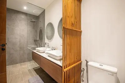 a bathroom with a sink and a shower and a toilet at Stunning 5BR Canggu Villa 400m from the Beach in Canggu