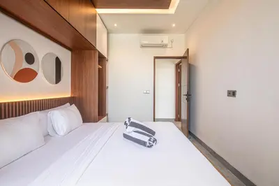 a bedroom with a white bed with a bag on it at Luxury 5-Bedroom Oasis 400 m to Canggu Sand in Canggu