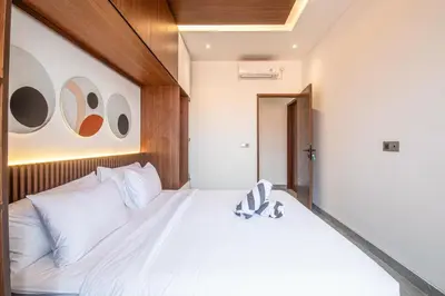 a bedroom with a white bed with white pillows at Serene 5-Bedroom Villa 400 m from Batu Bolong in Canggu