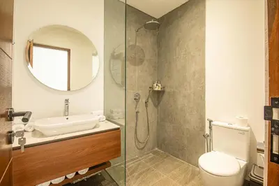 a bathroom with a sink and a toilet and a mirror at Serene 5-Bedroom Villa 400 m from Batu Bolong in Canggu