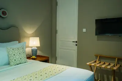 a bedroom with a bed and a flat screen tv at Anam Khaya - Brand New Villa, Walk to Seminyak Beach in Seminyak