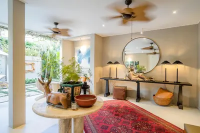 a living room with a table and a mirror at Anam Khaya - Brand New Villa, Walk to Seminyak Beach in Seminyak