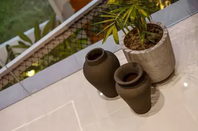 three green vases sitting on a table with a plant at Contemporary 2BR Luxury Villa with Rooftop View and Pool in Kerobokan