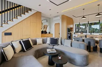 a living room with a couch and a table at Contemporary 2BR Luxury Villa with Rooftop View and Pool in Kerobokan