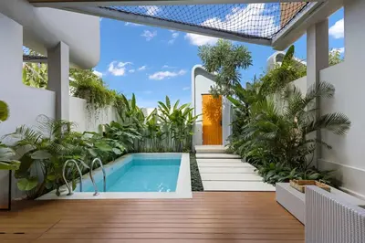 an indoor garden with a swimming pool and plants at Contemporary 2BR Luxury Villa with Rooftop View and Pool in Kerobokan