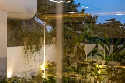a garden with plants and a water fountain at Contemporary 2BR Luxury Villa with Rooftop View and Pool in Kerobokan