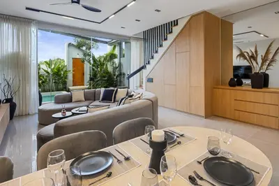 a living room with a couch and a table at Contemporary 2BR Luxury Villa with Rooftop View and Pool in Kerobokan
