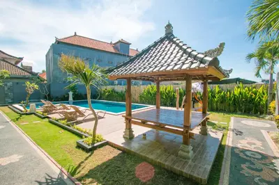 a gazebo next to a swimming pool at Srikandi Inn in Jimbaran
