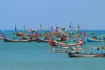 a group of boats sitting in the water at Srikandi Inn in Jimbaran