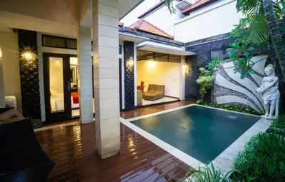 a house with a swimming pool in the middle of a yard at Kayu Suar Bali Luxury Villas & Spa in Sanur