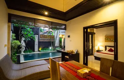 a room with a pool and a bedroom with a bed at Kayu Suar Bali Luxury Villas & Spa in Sanur