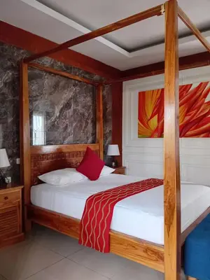 a bedroom with two bunk beds with white sheets at Casa Green Kori in Kerobokan