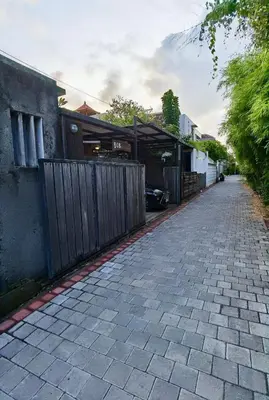 a brick road in front of a house with a fence at Bob's Hideaway Villa - Umalas in Umalas