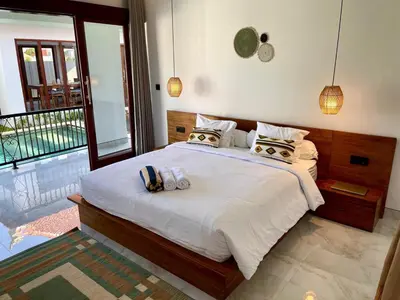 a bedroom with a large bed with towels on it at Chic Villa at Kubu Taullan 3B in Kerobokan
