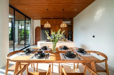 a dining room with a wooden table and chairs at New Luxury 3BR Villa walk to Atlas, Finns & Berawa beach in Canggu
