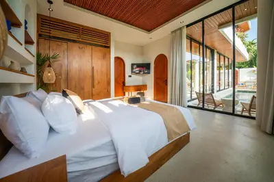 a bedroom with a large bed with white pillows at New Luxury 3BR Villa walk to Atlas, Finns & Berawa beach in Canggu