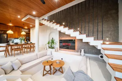 a living room with a white couch and a fireplace at New Luxury 3BR Villa walk to Atlas, Finns & Berawa beach in Canggu