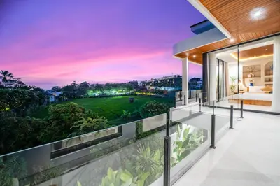 a view from the balcony of a house with a sunset at New Luxury 3BR Villa walk to Atlas, Finns & Berawa beach in Canggu